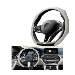 May include: A steering wheel cover in light gray and black, with a perforated texture on the light gray sections. The cover is shown on a black steering wheel with silver accents. The image also shows the steering wheel installed in a car.