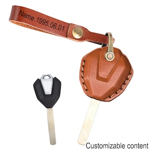 May include: A brown leather keychain with a key and a key fob. The keychain strap has the text "Name. 1995.06.01" embossed on it. The key fob is brown leather with a metal clasp. The text "Customizable content" is at the bottom.