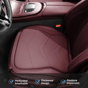 May include: A burgundy car seat cushion with a perforated texture and a chevron-patterned stitched design. The cushion is placed on a matching burgundy vehicle seat. Text at the bottom reads: Perforated breathable, Thickened Design, Pressure Dispersion.
