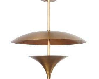 May include: A brass-colored, mid-century modern pendant light fixture. The fixture has a large, saucer-shaped shade above a smaller, inverted cone-shaped shade. A central rod connects the shades to a ceiling mount.