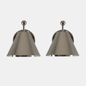 May include: Two matching silver-toned wall sconces. Each sconce features a conical shade, a circular backplate, and a small, spherical detail at the top. The sconces are designed for wall mounting and have a modern aesthetic.