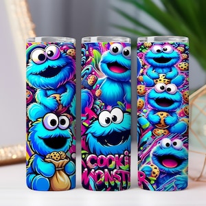 May include: Three stainless steel tumblers feature a vibrant design of the Cookie Monster character. The blue, furry monster is depicted with cookies and the words "Cookie Monster" in a colorful, graffiti-style font. The tumblers are approximately 8 inches tall.
