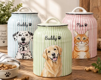 May include: Three ceramic storage canisters with lids, each featuring vertical stripes and a pet illustration. The blue canister shows a Dalmatian labelled Buddy, the green canister shows a Golden Retriever labelled Buddy, and the pink canister shows an orange tabby cat labelled Max.