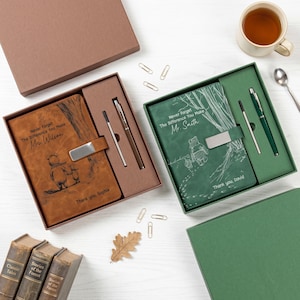 May include: Two gift sets, each containing a notebook and pen. One features a brown notebook with the text "Never Forget The Difference You Make Mrs. Wilson" and a Winnie the Pooh illustration. The other has a green notebook with the text "Never Forget The Difference You Make Mr. Smith".