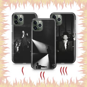 May include: Three black smartphone cases featuring black and white photographic prints of a performer in a suit on stage. Each case displays a different scene of the individual singing into a microphone under stage lights, with camera lens cutouts.