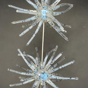 May include: A set of three ceramic mugs with a speckled, matte finish. The mugs are in shades of cream, light gray, and dark gray. Each mug has a simple, minimalist design, perfect for coffee or tea.