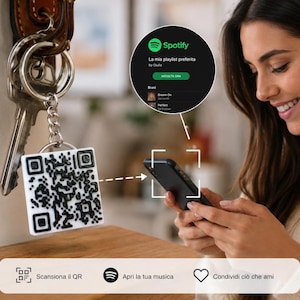 May include: A square white keychain featuring a raised black QR code pattern attached to a metal ring with keys. The QR code is designed to be scanned by a smartphone to open a Spotify playlist. The keychain includes a chain and a split ring.