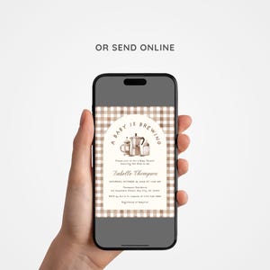 May include: A smartphone displays a baby shower invitation. The invitation features a brown and white gingham pattern background with the text "A Baby is Brewing" above a watercolor illustration of coffee-making equipment. The invitation includes event details.