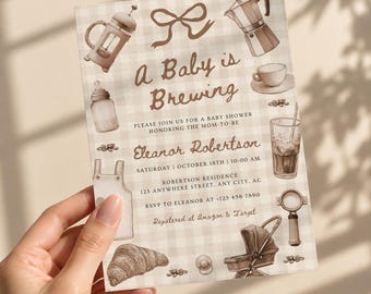 May include: A rectangular baby shower invitation card with a beige and white gingham pattern. It features brown illustrations of a French press, moka pot, baby bottle, stroller, and croissant. The text reads A Baby is Brewing, Eleanor Robertson, October 18th, 10:00 AM, and registry details.