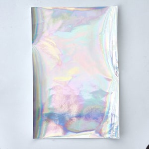 May include: A sheet of iridescent holographic paper with a rainbow of colors.