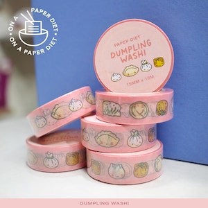 May include: Pink washi tape rolls with a dumpling theme. The tape features illustrations of various dumplings and the text "DUMPLING WASHI". Each roll is 15mm wide and 10 meters long.