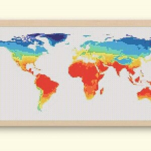 以下が含まれることがあります： 額装された世界地図のクロスステッチアート。 地図はピクセル化されたスタイルで表現されており、青から赤までの色で温度帯を表しています。 フレームは明るい木の色です。