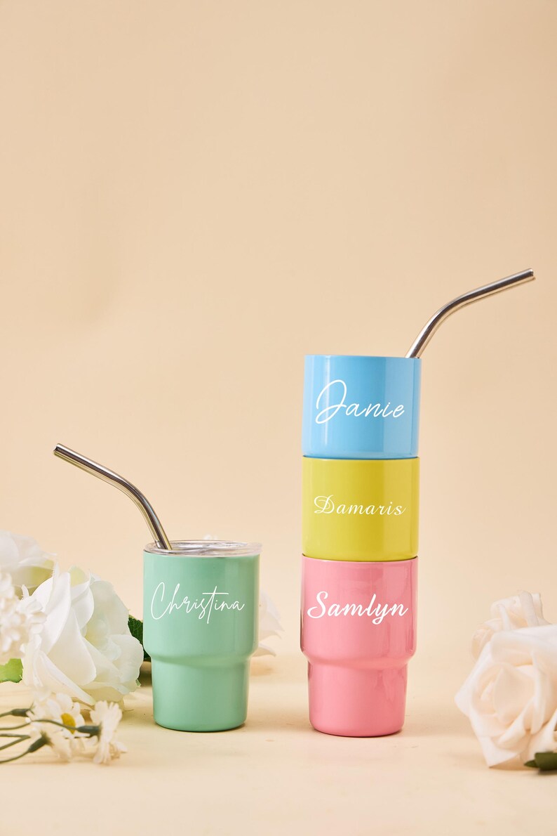 May include: A set of three ceramic mugs with a speckled, matte finish. The mugs are in shades of cream, light gray, and dark gray. Each mug has a simple, minimalist design and a rounded handle.
