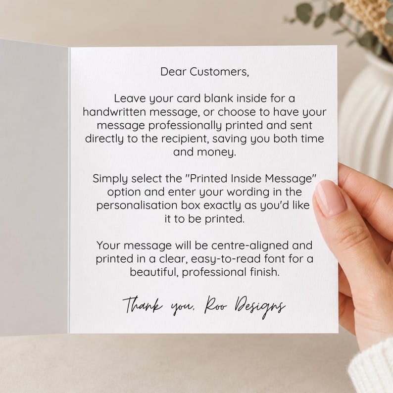 a hand holding a card with a handwritten message on it. The card appears to be a personalized message, and the person holding it is likely the card's recipient.