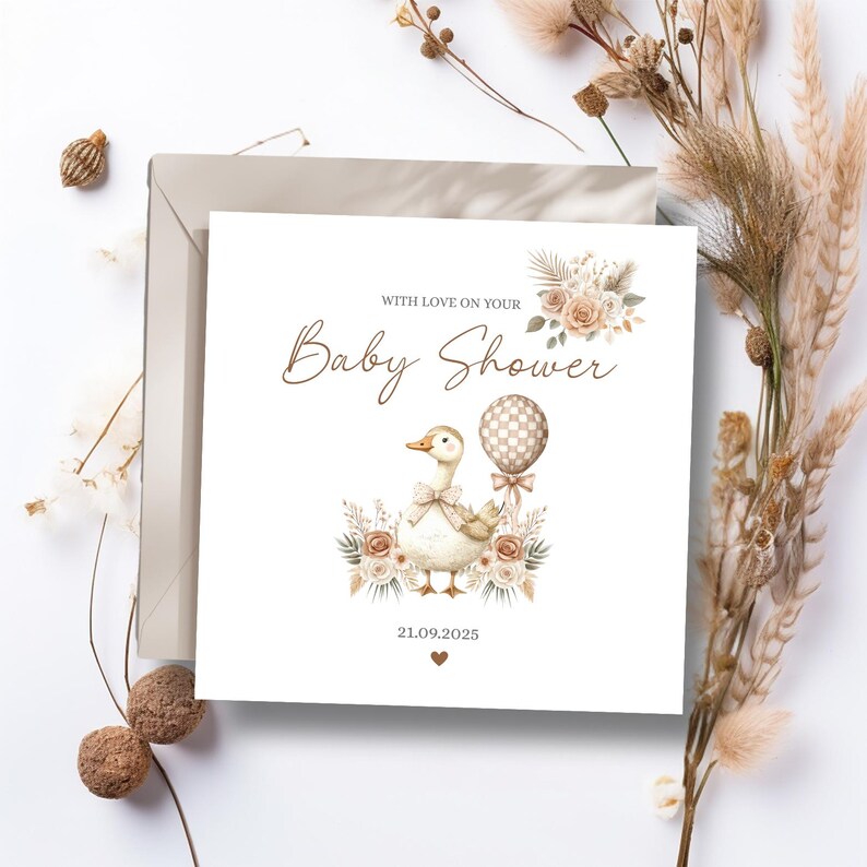 May include: A baby shower card featuring a duck illustration holding a balloon. The card includes the text "With Love on Your Baby Shower" and the date 21.09.2025. The card is surrounded by dried flowers and is square in shape.