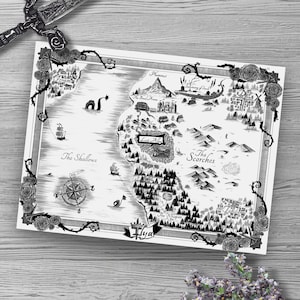 May include: Black and white fantasy map print with intricate details, including a compass, ships, and a sea monster. The map is framed with roses and vines, and a decorative sword is placed above it. The map features the text "Ilya" and various locations.