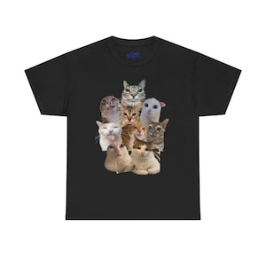 May include: Black t-shirt featuring a collage of nine different cat faces with various expressions. The cats are in shades of brown, white, and gray. The shirt has a crew neck and short sleeves.