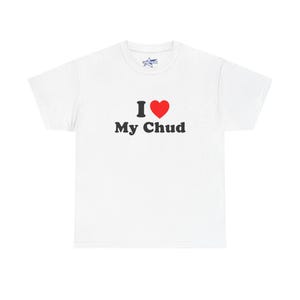 May include: White t-shirt with the text "I ❤️ My Chud" in black and red. The heart symbol is red. The shirt has a crew neck and short sleeves. A small logo is visible on the upper chest.