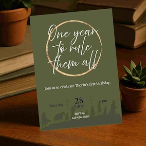 May include: An olive green birthday invitation with the text "One year to rule them all" in a gold circle. The invitation includes the date, time, and RSVP information. The bottom features a silhouette of figures.