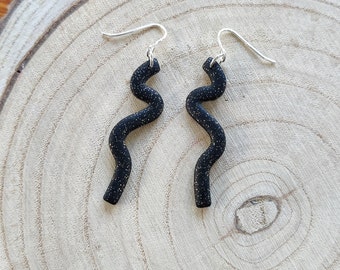 Black and gold glitter squiggle drop earrings on silver ear wire, bright lightweight polymer clay