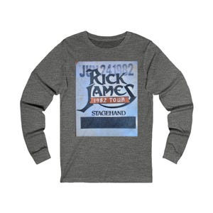 May include: A heather grey long-sleeve t-shirt with a vintage concert poster design featuring the text "Jun 24 1982 Rick James 1982 Tour Stagehand".