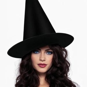 May include: A black witch hat with a wide brim and a tall, pointed crown. The hat is worn by a person with long, dark wavy hair and blue eyes. The person is wearing a white shirt.