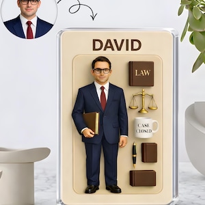 May include: A personalized desk ornament featuring a miniature figure of a man in a navy suit, glasses, and a red tie, holding a book. The ornament includes the name "DAVID" and law-related icons like scales, a book, a pen, and a mug that says "CASE CLOSED".