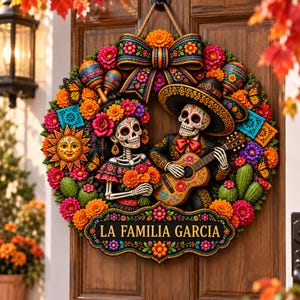 May include: A decorative wreath featuring two skeleton figures, one holding a bouquet and the other playing a guitar. The wreath is adorned with colorful marigolds, maracas, butterflies, cacti, and a central sign reading LA FAMILIA GARCIA.