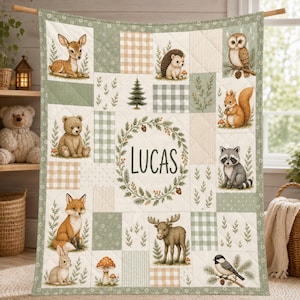 May include: A quilted blanket featuring a central wreath with the name LUCAS, surrounded by illustrations of a deer, hedgehog, owl, squirrel, raccoon, fox, moose, rabbit, and bird, set against sage green and beige plaid and floral patterns.