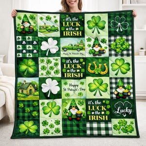 May include: A green and white patchwork quilt featuring St. Patrick's Day imagery. The quilt includes shamrocks, gnomes, horseshoes, and the text "It's the Luck of the Irish" and "Happy St. Patrick's Day". The quilt has a green border.