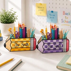 May include: Two pencil-shaped desk organizers, one yellow and one purple, both featuring a checkered pattern and the text Mr. Smith. Each holder contains an assortment of colored pencils, paintbrushes, and a pair of purple scissors.