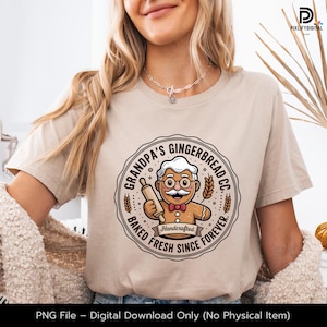 May include: Beige t-shirt featuring a circular graphic of a gingerbread man with glasses, a mustache, and a bow tie, holding a rolling pin. The graphic reads "Grandpa's Gingerbread Co." and "Baked Fresh Since Forever." The shirt is a digital download.