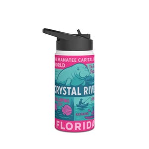 May include: A white water bottle with a black lid and a pink and teal graphic. The graphic features a manatee, the words "Crystal River Florida", and illustrations of kayaking and fishing. The bottle is designed for outdoor activities.