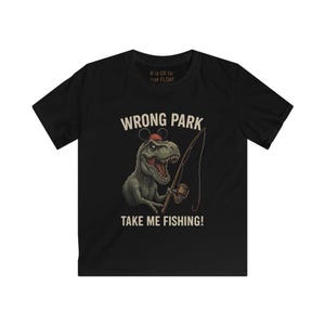May include: Black t-shirt with a cartoon dinosaur wearing a Mickey Mouse hat and fishing rod. Text says "WRONG PARK TAKE ME FISHING!" and "It is OK to just FLOAT".