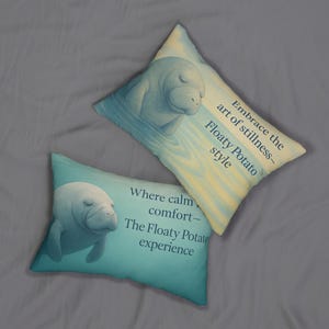 May include: Two decorative pillows featuring manatee artwork. One pillow displays the text "Embrace the art of stillness - Floaty Potato style." The other reads "Where calm comfort - The Floaty Potato experience."