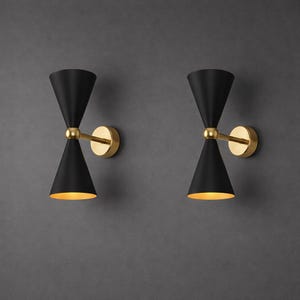 May include: A white ceramic mug with a black handle and the text "But First, Coffee" in a black, handwritten-style font. The mug is on a white surface.