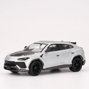 May include: A silver and black model car with black wheels. The car has a black hood and a spoiler. The car is a miniature replica of a luxury SUV.