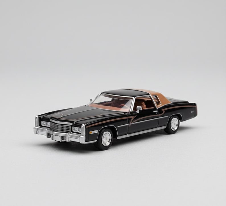 May include: A black and tan classic car model with chrome accents. The miniature vehicle features a brown roof, a detailed interior, and a shiny black exterior. The car has a rectangular chrome grill and silver rims.