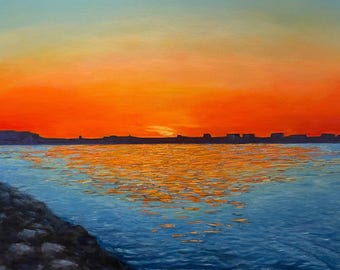 May include: An oil painting depicts a vibrant sunset over a body of water. The sky transitions from blue to orange, reflecting on the water's surface. A dark shoreline and rocky foreground add depth to the landscape.