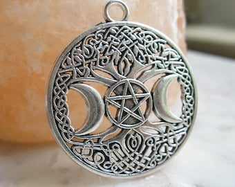 May include: Silver pendant featuring a tree of life design with three crescent moons and a pentagram in the center. The pendant is surrounded by a Celtic knot border.