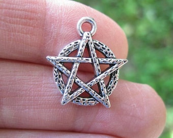May include: Silver-toned pendant charm featuring a five-pointed star with a textured surface. The star is a pentagram, a symbol often associated with witchcraft and paganism.