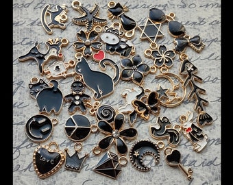 Collection of Black charms with gold tone backing - C4087