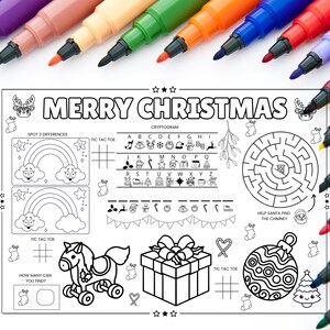 May include: A black and white Christmas activity placemat with the text "MERRY CHRISTMAS" and various games, including a maze, tic-tac-toe, and a cryptogram. Colorful markers are arranged around the placemat.