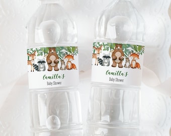 May include: Two clear plastic water bottles with labels featuring a woodland animal theme. The labels have a green, brown, and white colour scheme and say "Camilla's Baby Shower".