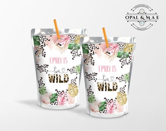 May include: Two juice box pouches with a jungle theme. The pouches are white with a leopard print background and pink and green floral accents. The text on the pouches reads "Emily is two wild".