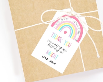 May include: A gift wrapped in brown paper, tied with twine, and a white tag. The tag features a rainbow design with the text "THANK YOU for making my birthday so BRIGHT" and "LOVE, JENNI".