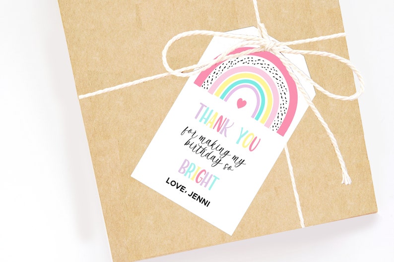 May include: A gift wrapped in brown paper, tied with twine, and a white tag. The tag features a rainbow design with the text "THANK YOU for making my birthday so BRIGHT" and "LOVE, JENNI".