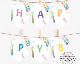 May include: A colorful banner with the word "HAPPY" spelled out in individual pennants. Each pennant features a watercolor paint palette, paintbrushes, and pencils. The banner is strung on a white string with wooden clothespins.