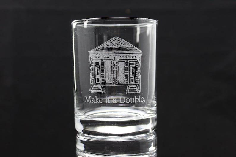 May include: A clear glass shot glass with an etched design of a house with the text "Make it a Double."