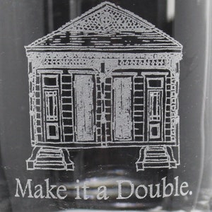 May include: Etched glass with a black and white image of a New Orleans style house. The text "Make it a Double." is below the image.